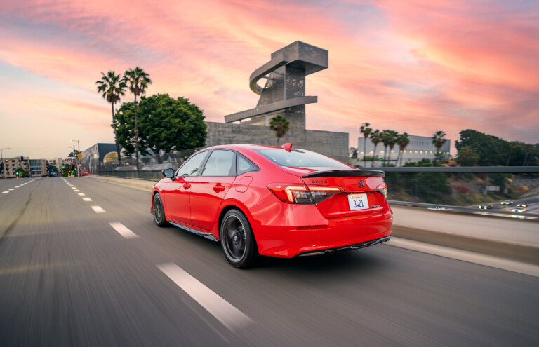 Wheels Reviews 2022 Honda Civic Touring Sedan Red US Spec Dynamic Rear Side Sunset