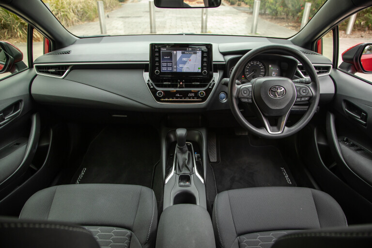Wheels Reviews 2021 Toyota Corolla Ascent Sport Hybrid Jasper Red Interior Dashboard