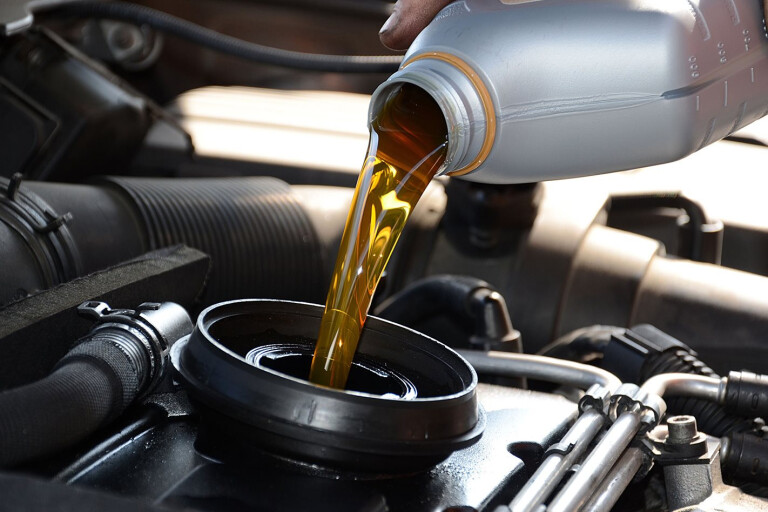 Engine oil being poured into car