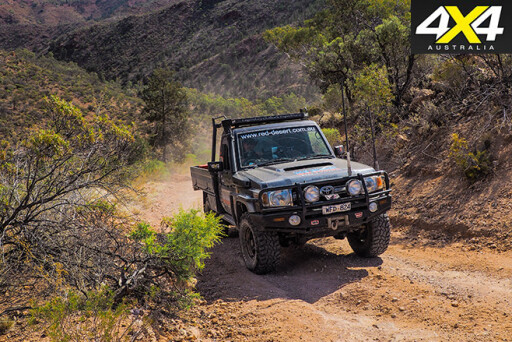 Red desert Land Cruiser driving uphill