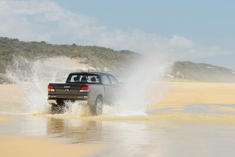 Mazda BT-50 at Fraser Island rear driving on sand water