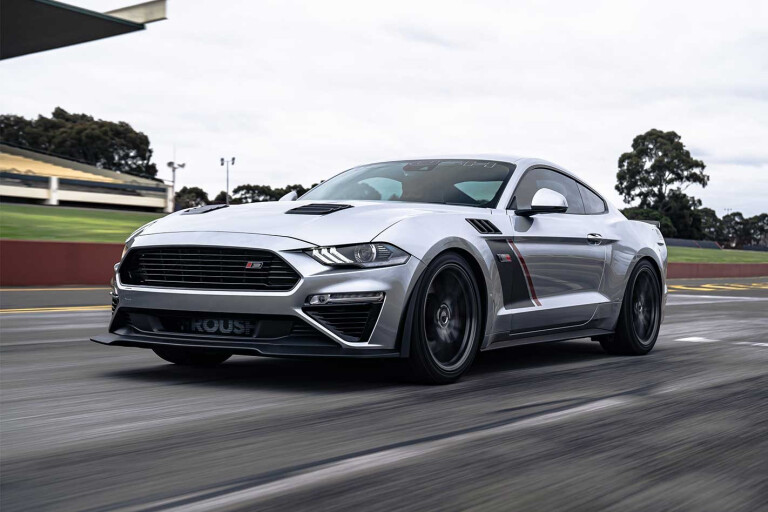 Supercharged Ford Mustang driving on track.