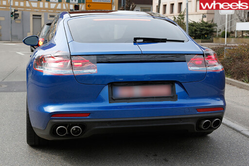 Blue -Porsche -Panamera -driving -rear