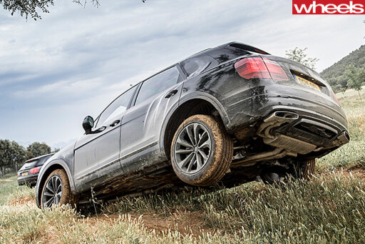 Bentley -Bentayga -driving -through -dirt -track