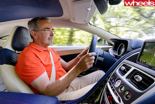 John -Carey -driving -Aston -Martin -DB11-interior