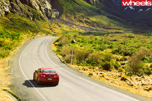 Nissan -GT-R-rear -driving -road -mountains
