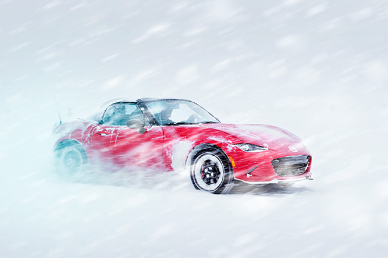 Mazda MX-5 convertible driving snow