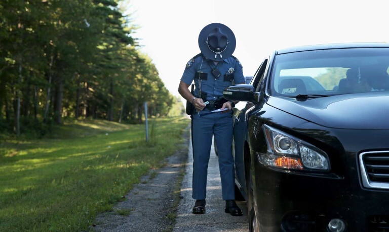 Policeman issuing speeding ticket