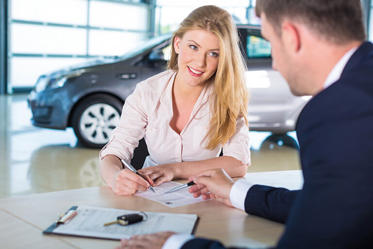 Woman signing car contract