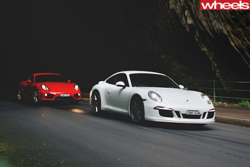Porsche -Cayman -vs -Porsche -911-Carrera -S-driving -front
