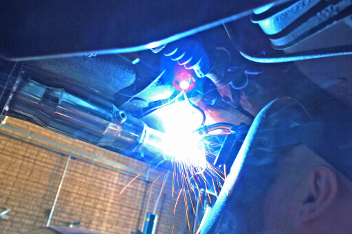 at is welded into place on the existing stainless-steel exhaust pipe