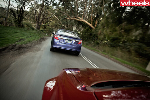 2012-Toyota -Camry -Hybrid -driving -rear -Australian -car