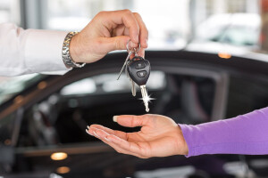 Car Salesperson Handing Over Keys To New Car Jpg