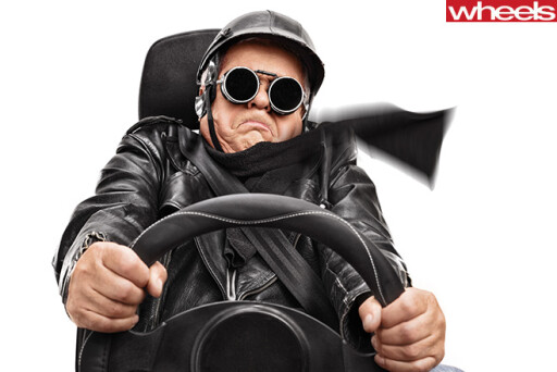Elderly -man -holding -steering -wheel