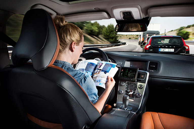 Woman reading magazine in car