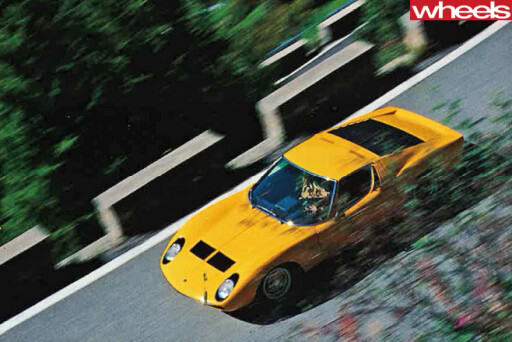 Yellow -Lamborghini -Muira -front -driving -road -top -side