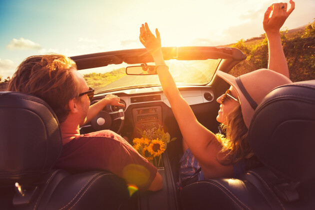 Happy Couple In Convertible In Sun Laughing Jpg