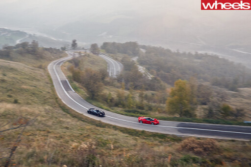 Mc Laren -vs -Ferrari -driving -road-