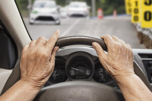 elderly driver hands on steering wheel