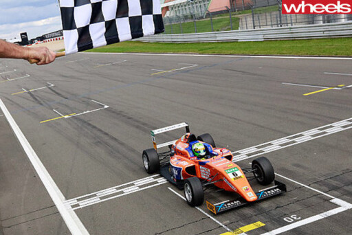 Australia -Formula -4-racing -car -passing -chequered -flag