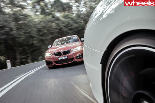 2014 BMW M235i driving front with CLA45