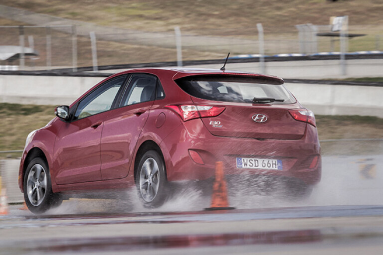 Hyundai i30 rear driving on wet road test track