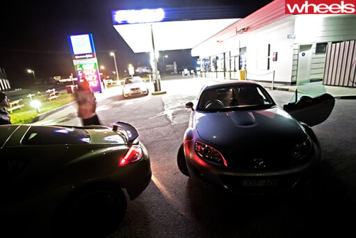 Mazda -MX-5-and -Porsche -Cayman -at -petrol -station