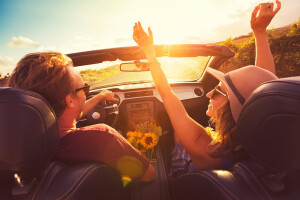 Happy Couple In Convertible In Sun Laughing Jpg